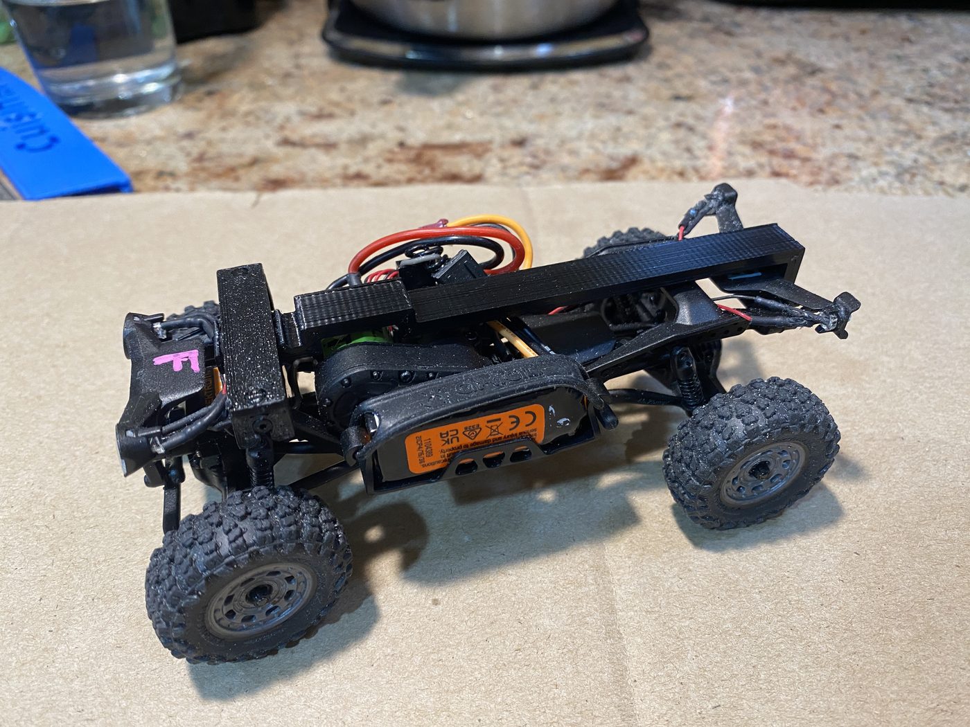 The spine rail installed on a bare SCX30 chassis, seen from the side.